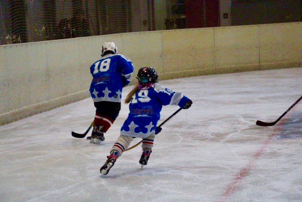 Kontakt: Foto Mädchen und Junge beim Eishockey